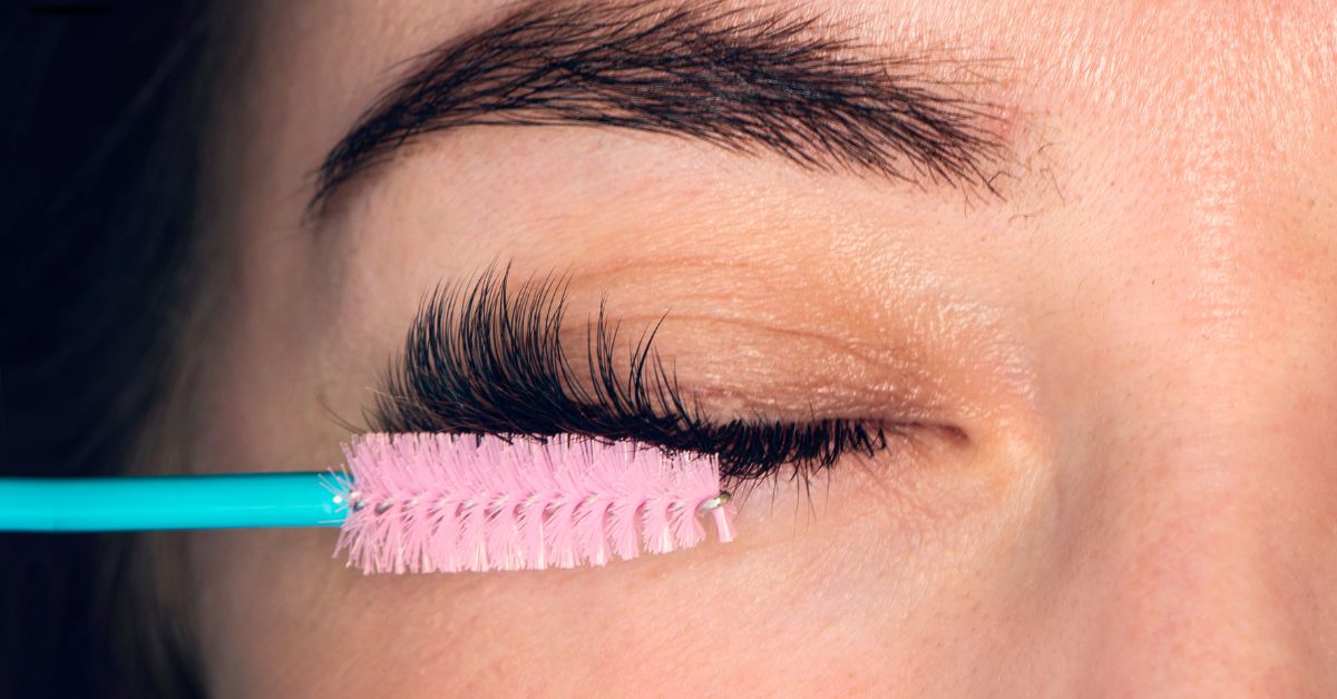 Woman combing eyelashes